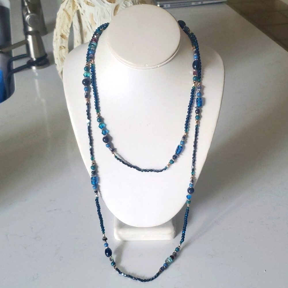 Long necklace, multiple beads in different shades of blue color.